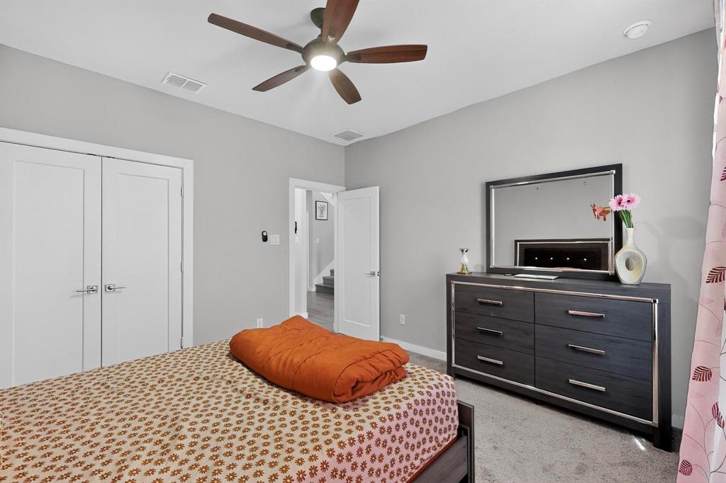 4036 Fanleaf Loop Melissa, TX 75454 - Photo 14 of 19 a bedroom with a bed and a tv on a dresser