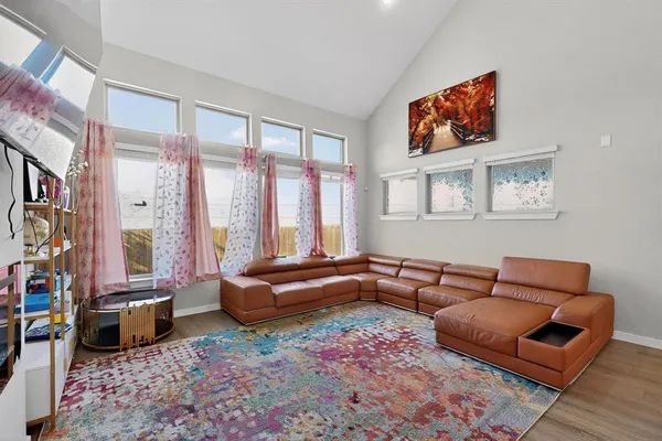 a living room with furniture a rug and a large window