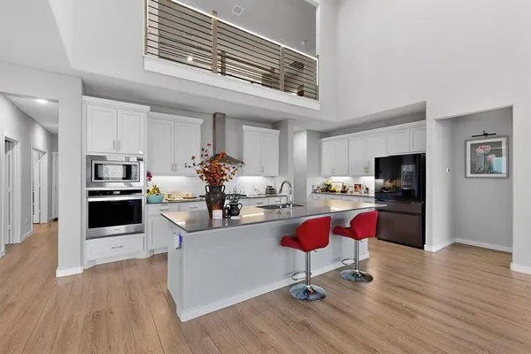 a kitchen with granite countertop a stove and cabinets