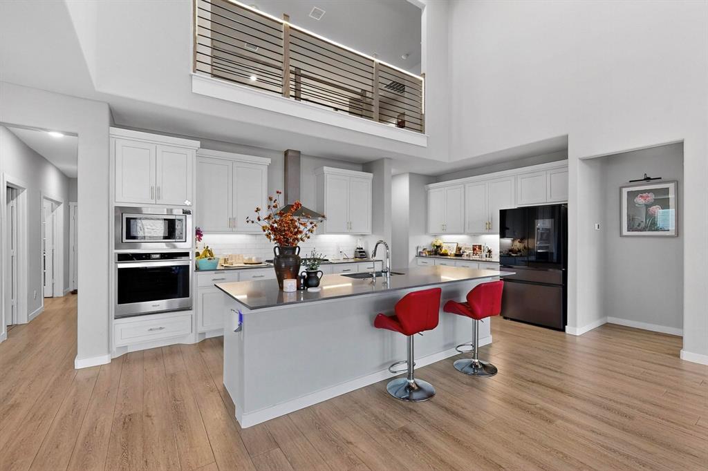 4036 Fanleaf Loop Melissa, TX 75454 - Photo 7 of 19 a kitchen with granite countertop a stove and cabinets