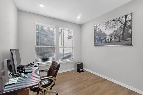 a view of a workspace with furniture and a window