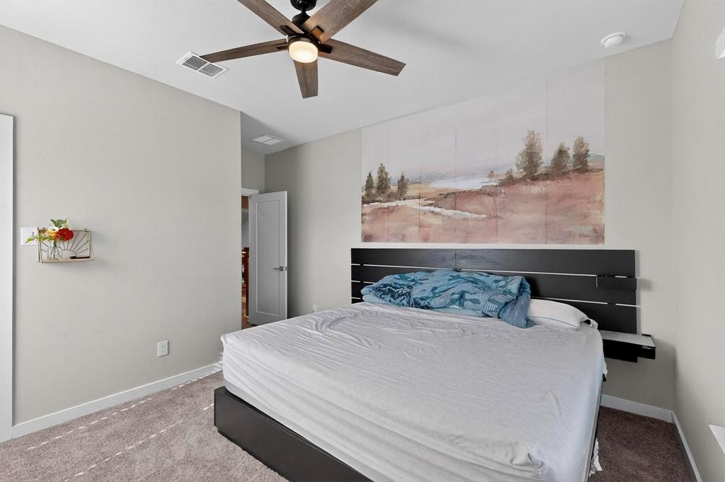 4036 Fanleaf Loop Melissa, TX 75454 - Photo 9 of 19 a bedroom with a bed and a chandelier