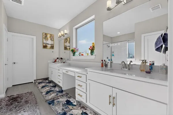 a bathroom with a shower and a sink