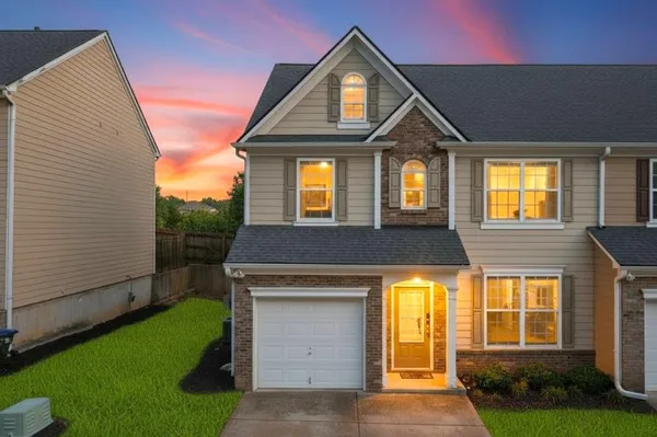 a front view of a house with a yard