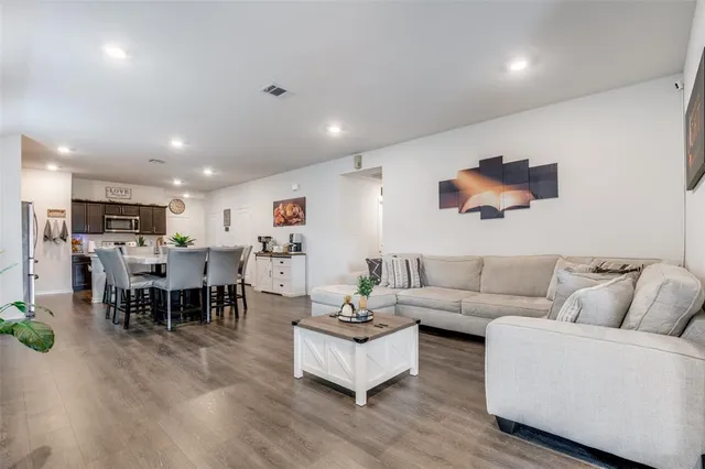 a living room with furniture kitchen view and a dining table