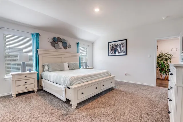 a bedroom with a bed and window