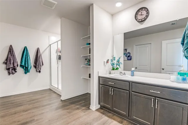 a view of bathroom with a sink and a mirror
