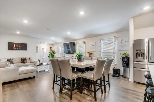 a view of a dining room with furniture and wooden floor
