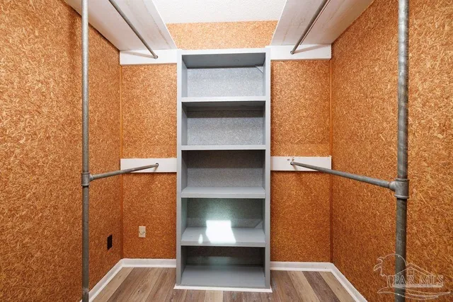 a view of walk in closet with empty room