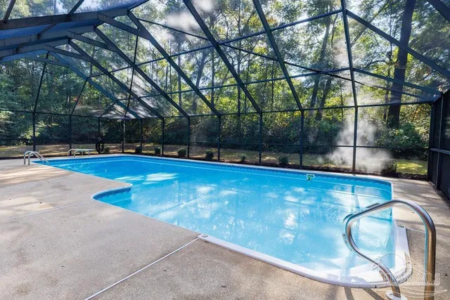 a view of a swimming pool with a yard