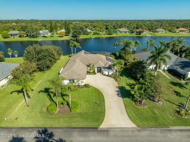 an aerial view of a house with a lake view