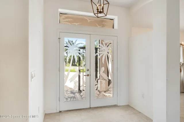 a view of a room with a windows and ceiling fan