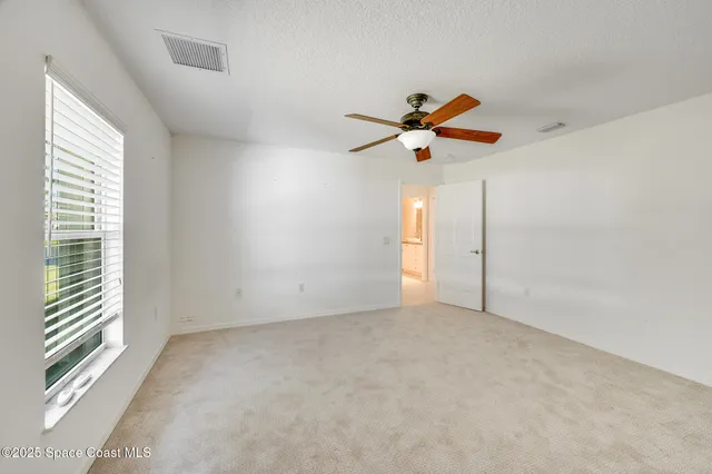 a bathroom with a granite countertop sink a mirror and a bathtub