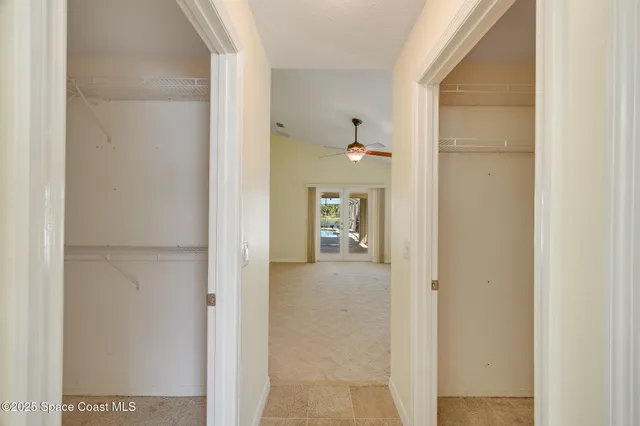 a white toilet sitting next to a white wall