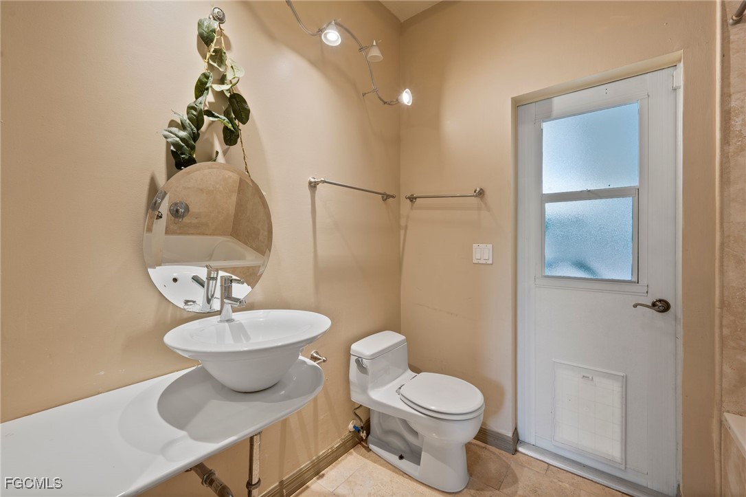 1981 Carbonata Drive Alva, FL 33920 - Photo 23 of 50 a bathroom with a toilet sink and mirror
