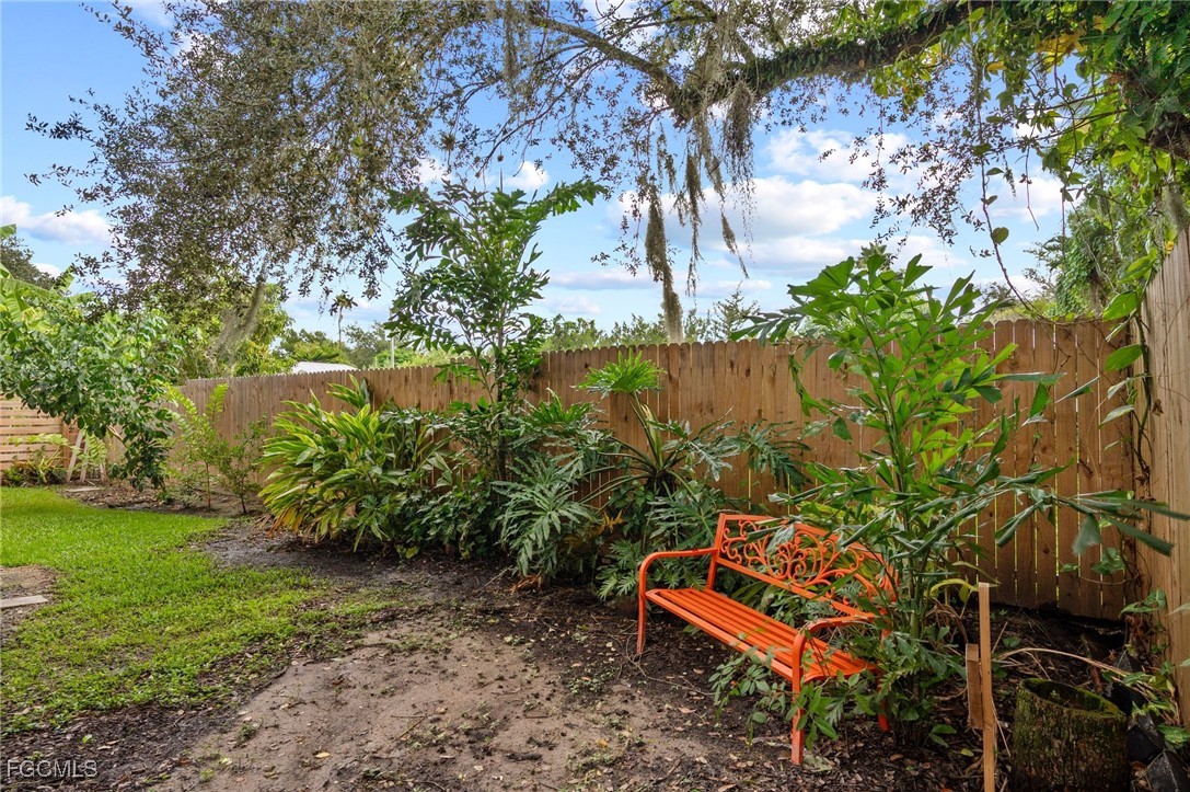 1981 Carbonata Drive Alva, FL 33920 - Photo 47 of 50 a wooden bench sitting in the middle of a garden