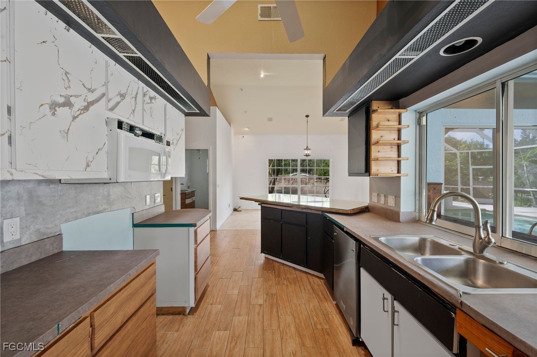 1981 Carbonata Drive Alva, FL 33920 - Photo 9 of 50 a kitchen with granite countertop a sink stove and cabinets