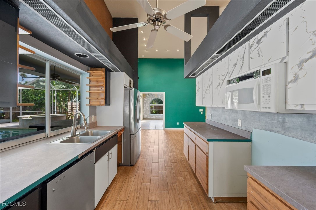 1981 Carbonata Drive Alva, FL 33920 - Photo 10 of 50 a kitchen with kitchen island stainless steel appliances a sink stove and cabinets