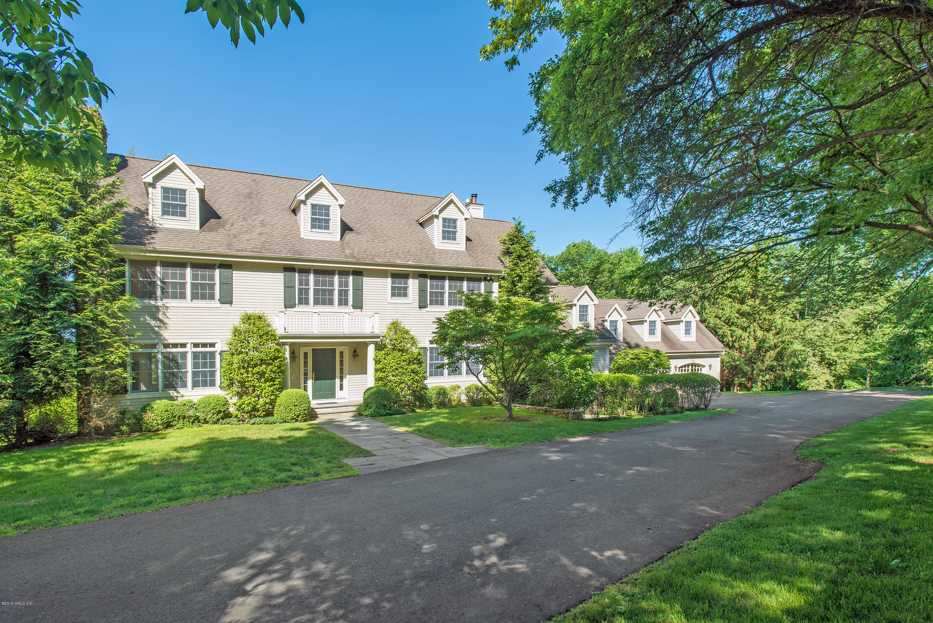 108 Cutler Road Greenwich, CT 06831 - Photo 1 of 15 a front view of a house with a garden