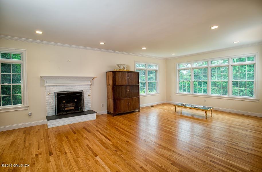 108 Cutler Road Greenwich, CT 06831 - Photo 3 of 15 a view of an empty room with a fireplace and a window