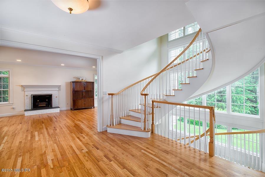 108 Cutler Road Greenwich, CT 06831 - Photo 6 of 15 a view of empty room with wooden floor and fireplace