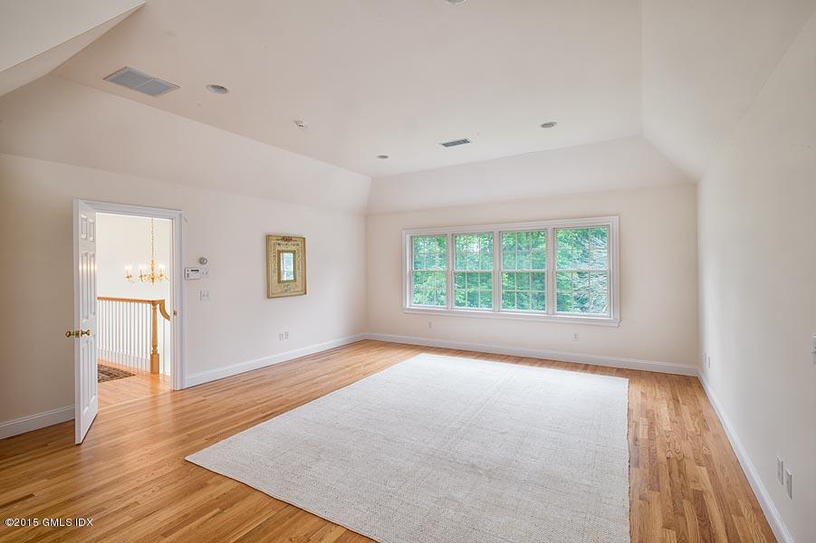 108 Cutler Road Greenwich, CT 06831 - Photo 7 of 15 a view of an empty room with wooden floor and a window