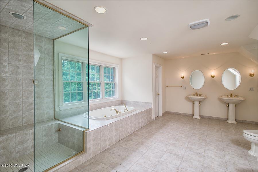 108 Cutler Road Greenwich, CT 06831 - Photo 8 of 15 a spacious bathroom with a shower a sink and a mirror