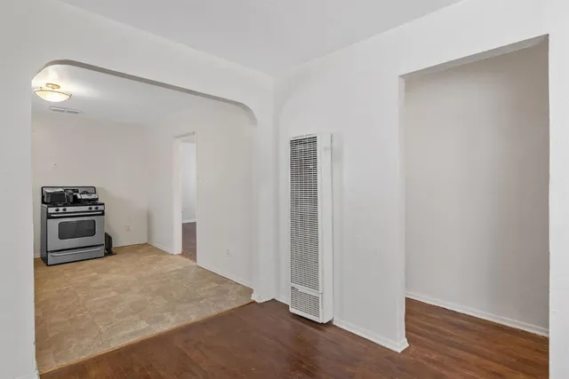 a kitchen with a refrigerator and a stove top oven