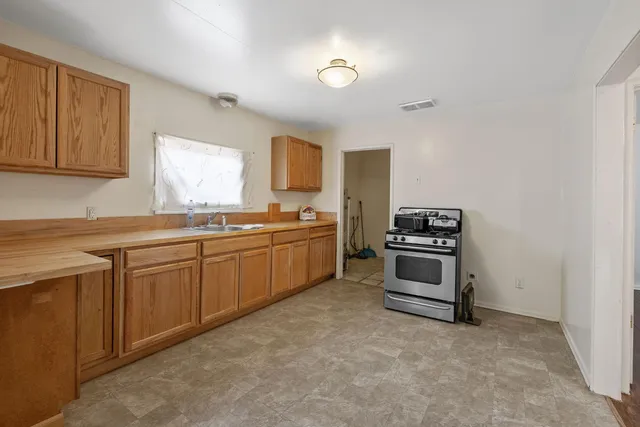 a kitchen with cabinets and window