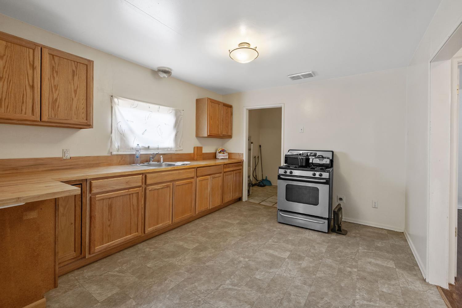 400 Scott Street Hanford, CA 93230 - Photo 12 of 35 a kitchen with cabinets and window
