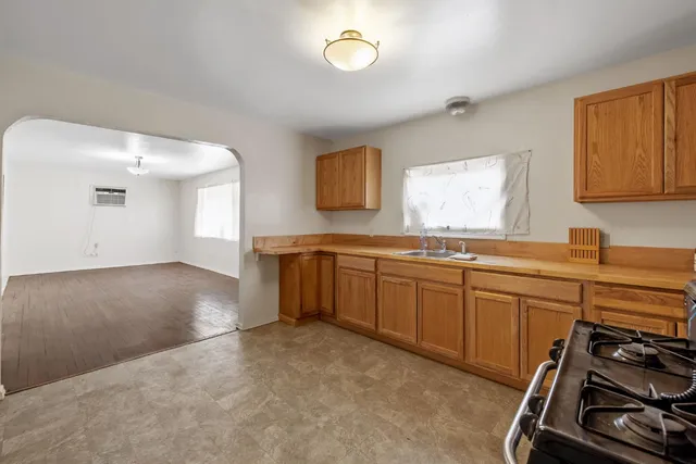 a kitchen with a sink stove and cabinets