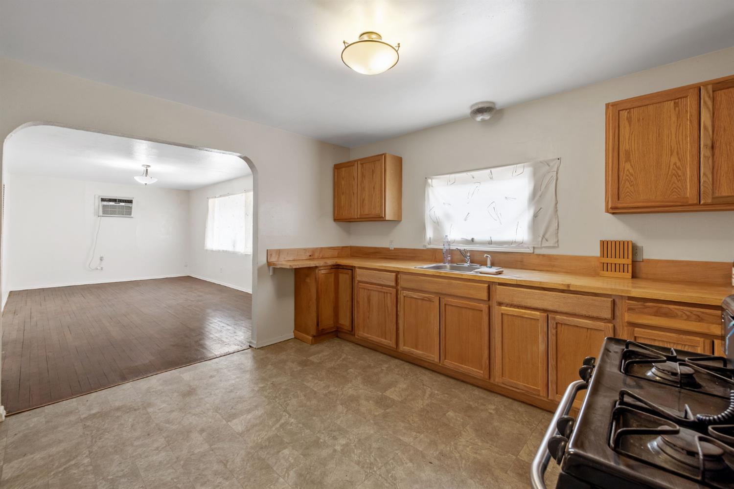400 Scott Street Hanford, CA 93230 - Photo 14 of 35 a kitchen with a sink stove and cabinets