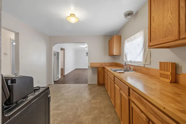 a kitchen with a sink stove and cabinets