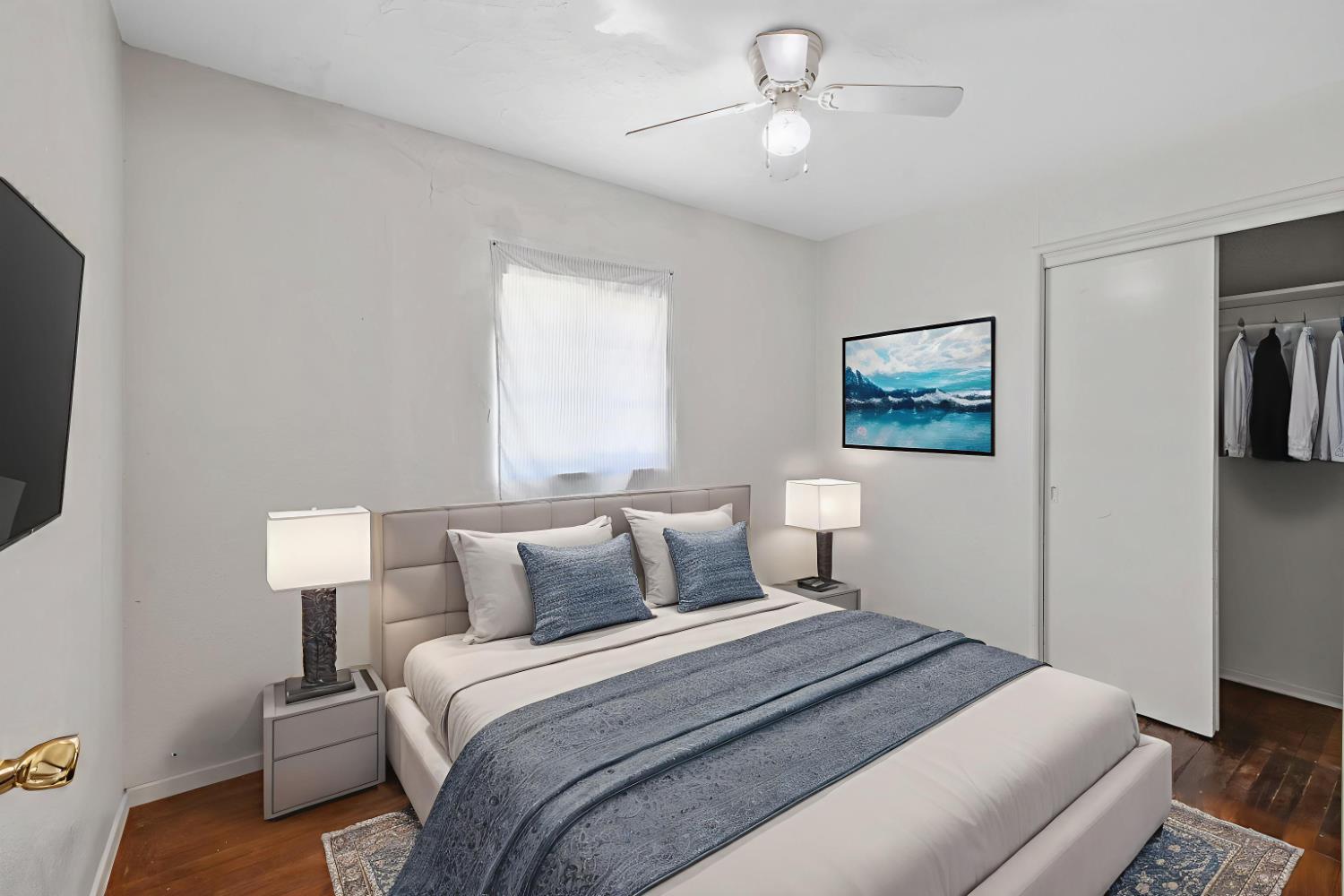 400 Scott Street Hanford, CA 93230 - Photo 19 of 35 a bedroom with a large bed and a tv