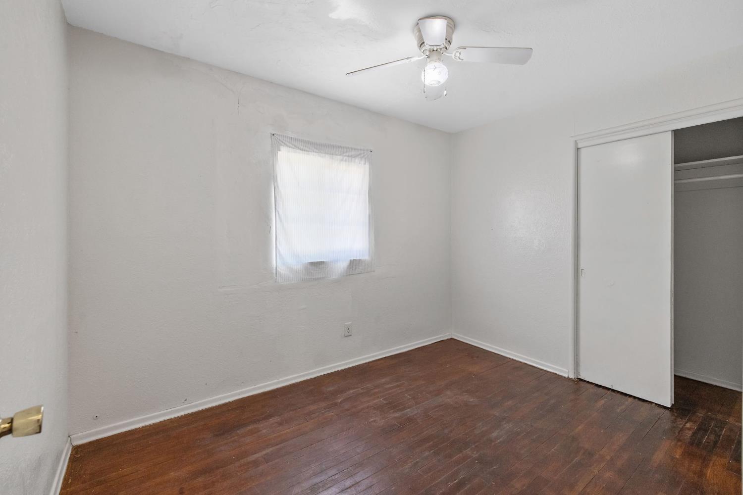 400 Scott Street Hanford, CA 93230 - Photo 20 of 35 wooden floor in an empty room with a window