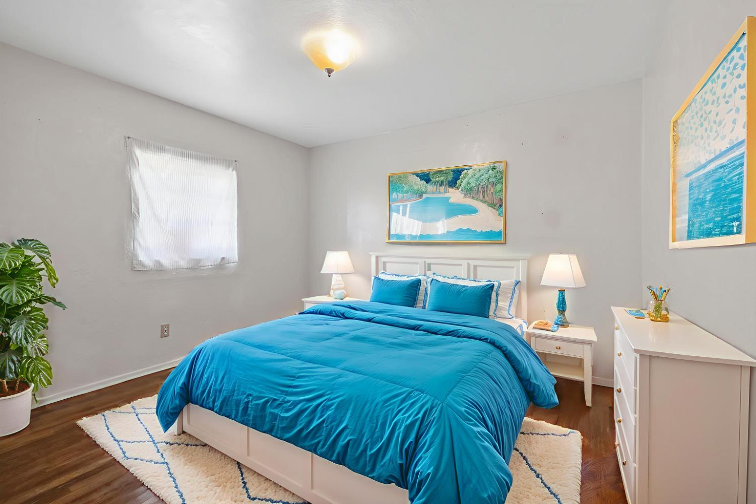 400 Scott Street Hanford, CA 93230 - Photo 25 of 35 a bedroom with a bed and a painting on the wall