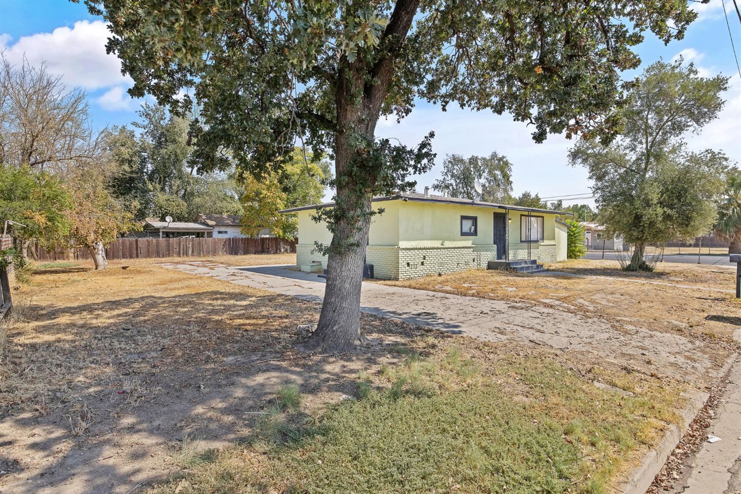 400 Scott Street Hanford, CA 93230 - Photo 4 of 35 a front view of a house with a yard and trees