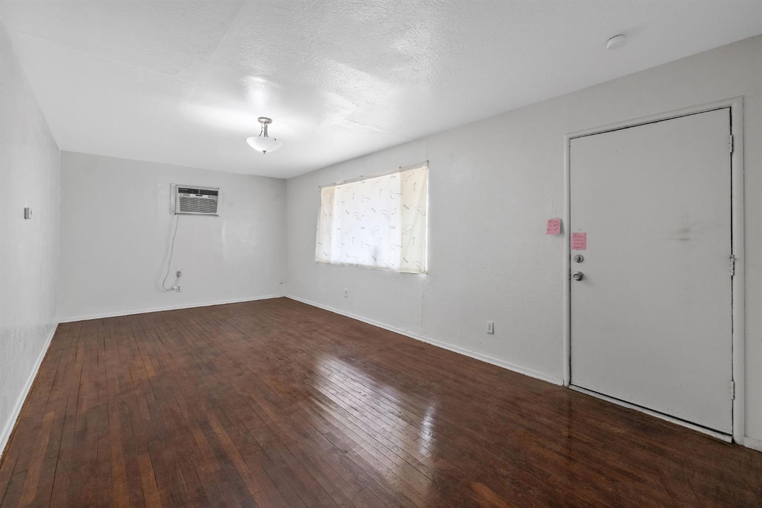 400 Scott Street Hanford, CA 93230 - Photo 7 of 35 an empty room with wooden floor and windows