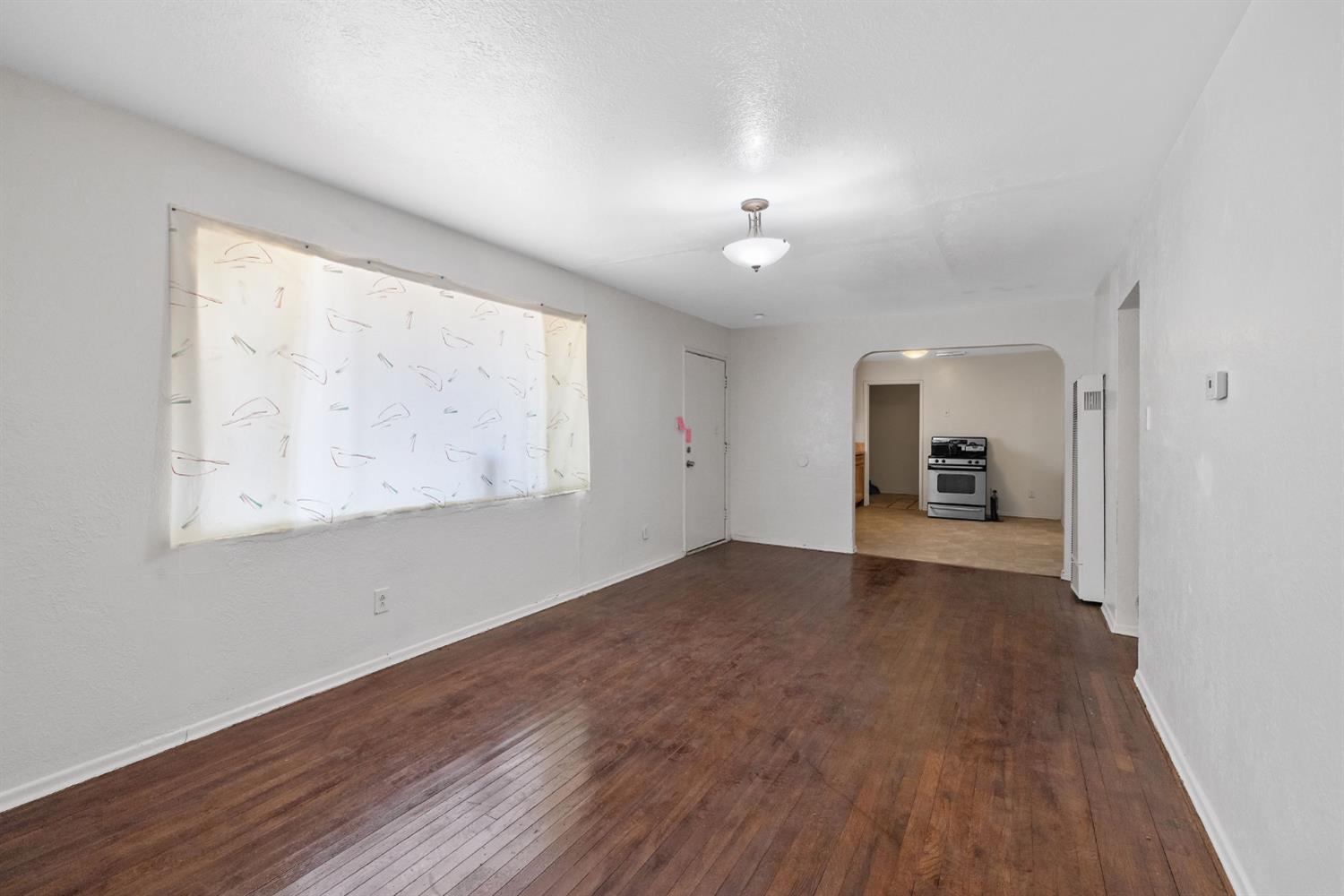 400 Scott Street Hanford, CA 93230 - Photo 8 of 35 a view of a big room with wooden floor and a window