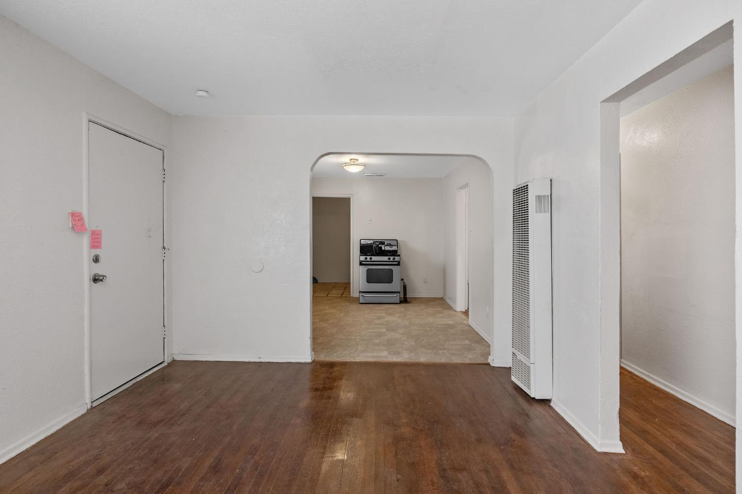 400 Scott Street Hanford, CA 93230 - Photo 10 of 35 a view of a hallway with wooden floor and a bathroom