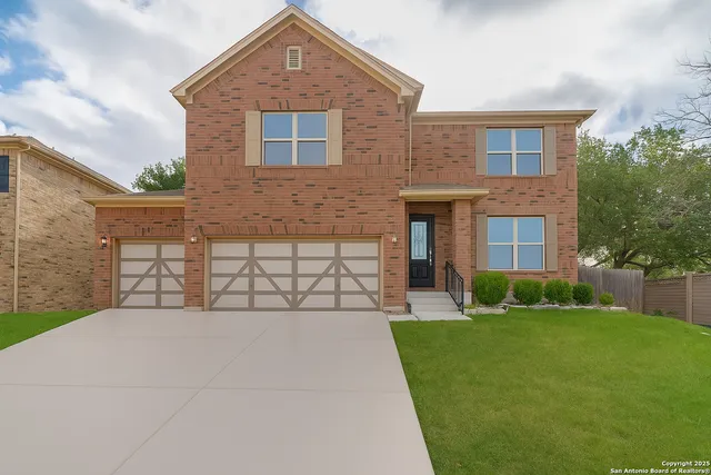 a front view of a house with a yard and garage