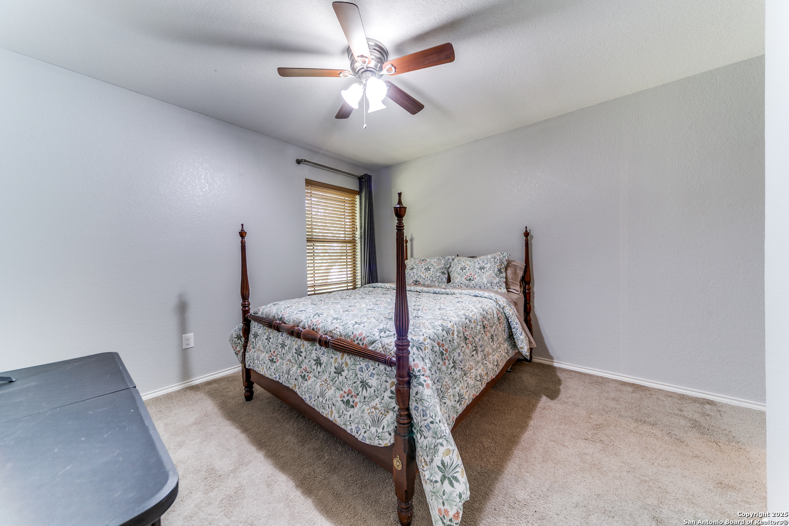 153 Rattlesnake Bluff Boerne, TX 78006 - Photo 15 of 18 a bedroom with a bed and a chandelier