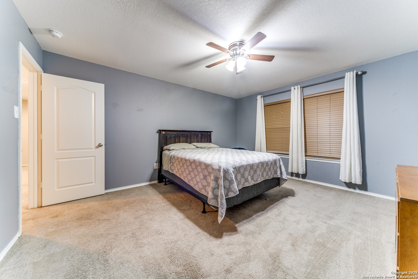 153 Rattlesnake Bluff Boerne, TX 78006 - Photo 16 of 18 a bed sitting in a spacious bedroom next to a window