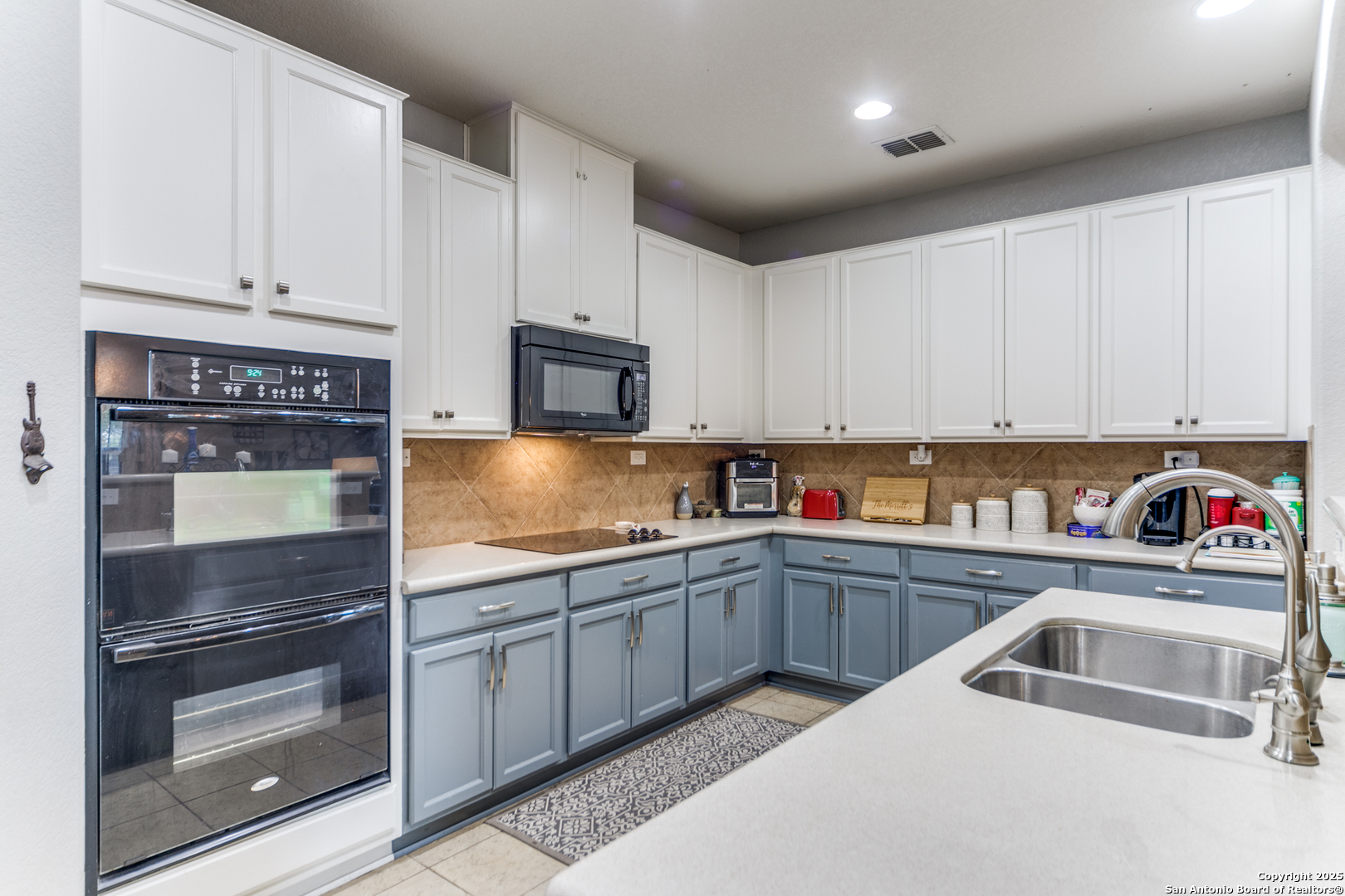 153 Rattlesnake Bluff Boerne, TX 78006 - Photo 6 of 18 a kitchen with sink cabinets and stainless steel appliances