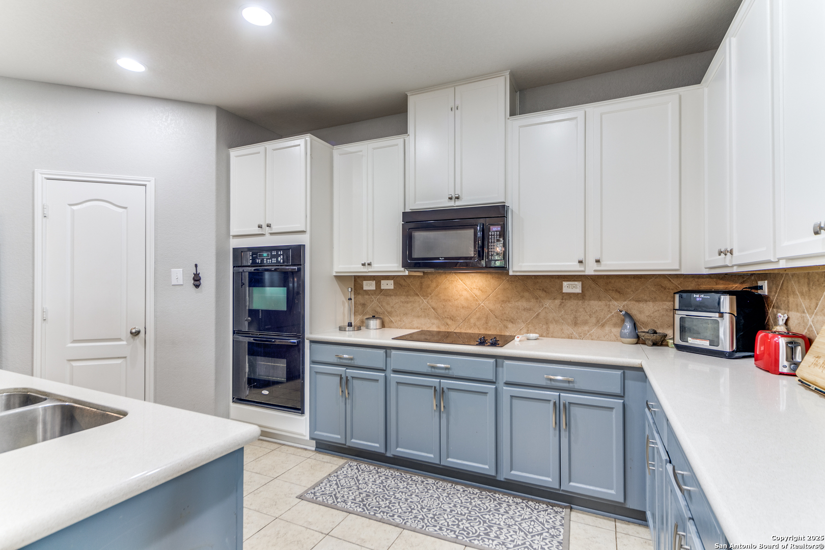 153 Rattlesnake Bluff Boerne, TX 78006 - Photo 7 of 18 a kitchen with stainless steel appliances granite countertop a sink and cabinets