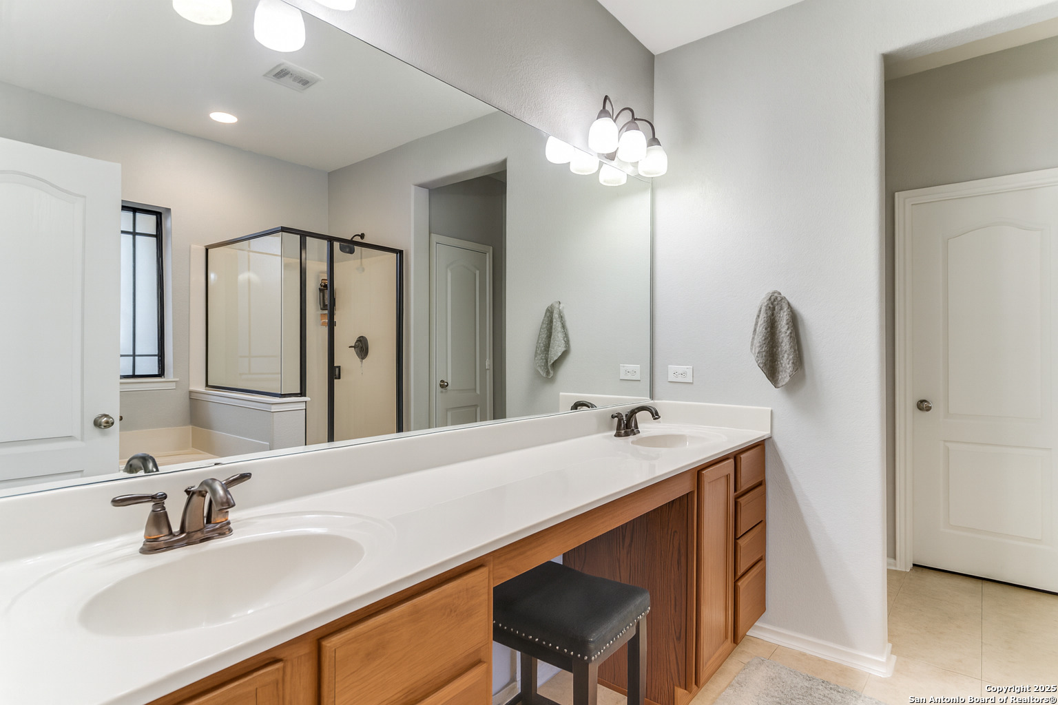 153 Rattlesnake Bluff Boerne, TX 78006 - Photo 9 of 18 a bathroom with a sink double vanity granite tub and a mirror