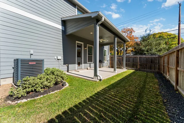 a view of a house with backyard and porch