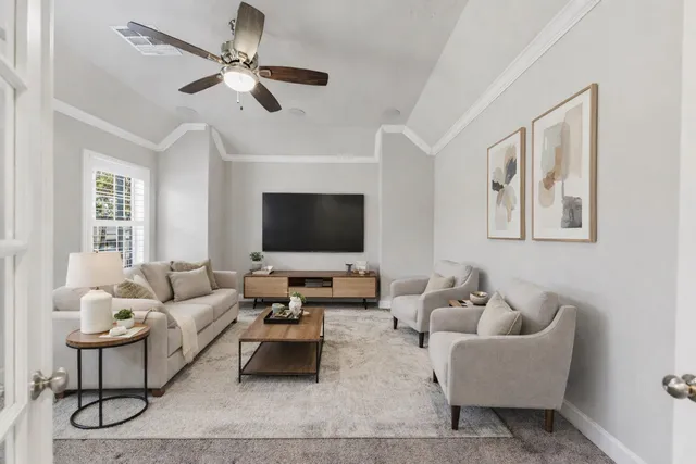 a living room with furniture and a flat screen tv