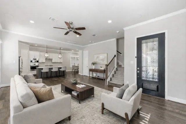 a living room with furniture and a ceiling fan