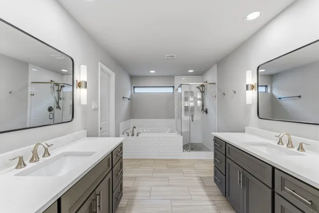 a spacious bathroom with a bathtub shower sink double and mirror